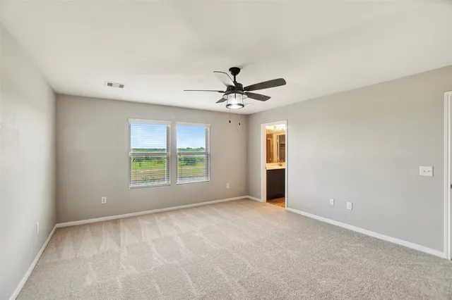 a view of a livingroom with a ceiling fan and window