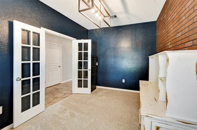 a bedroom with a bed and a refrigerator