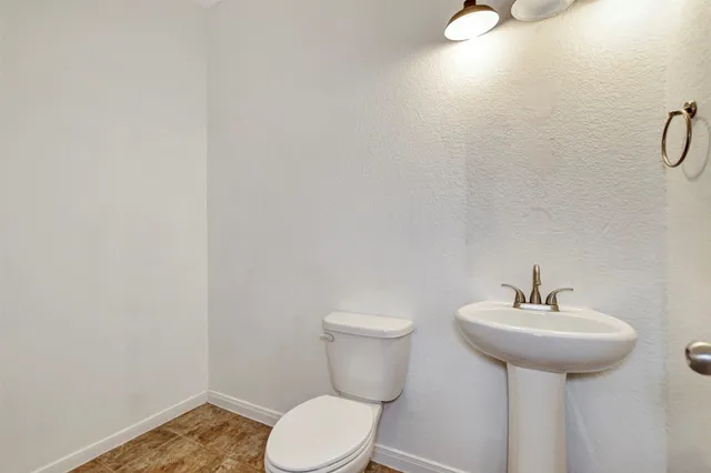 a large kitchen with a refrigerator and a sink