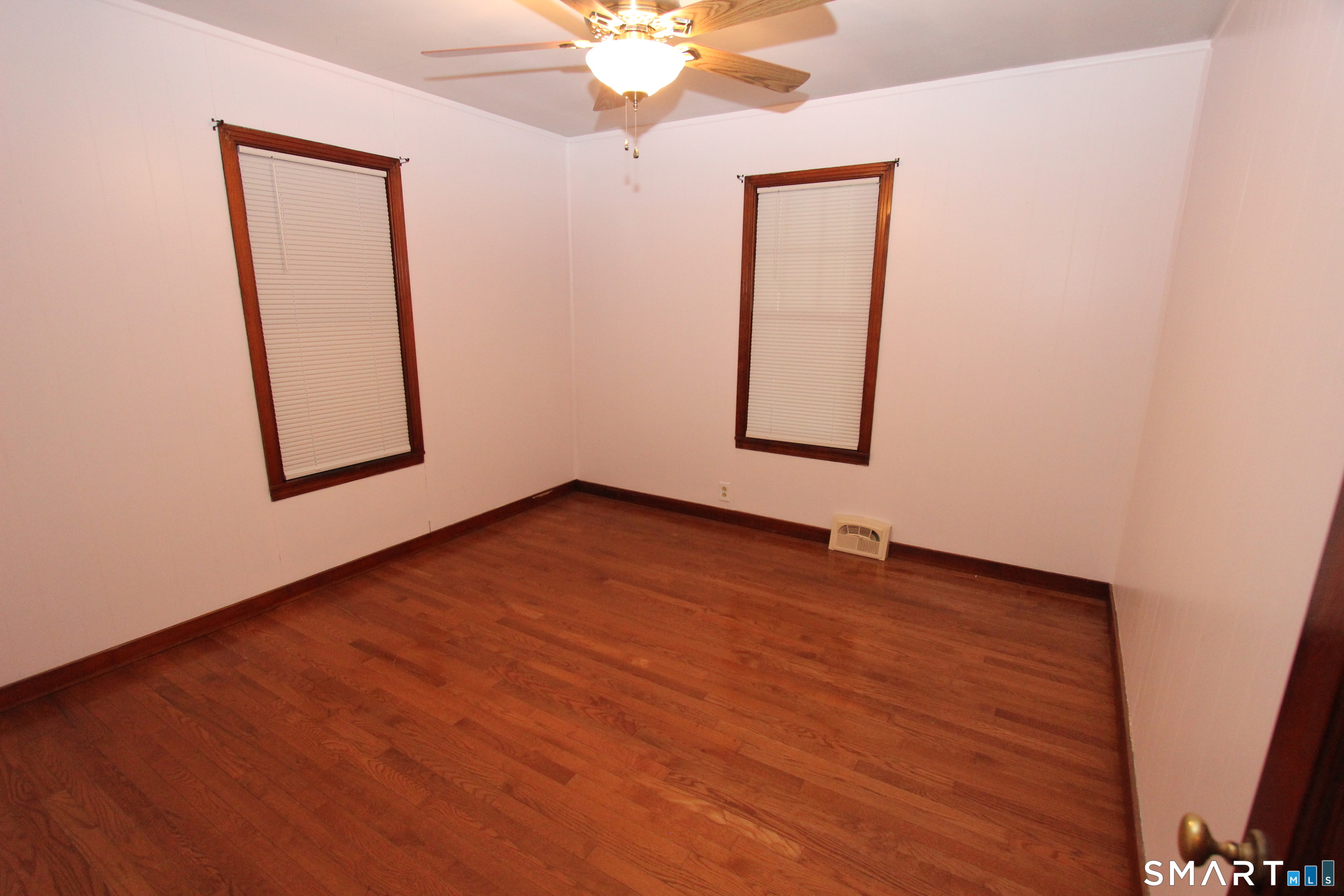 22 Brook Street Seymour, CT 06483 - Photo 11 of 13 an empty room with window and wooden floor