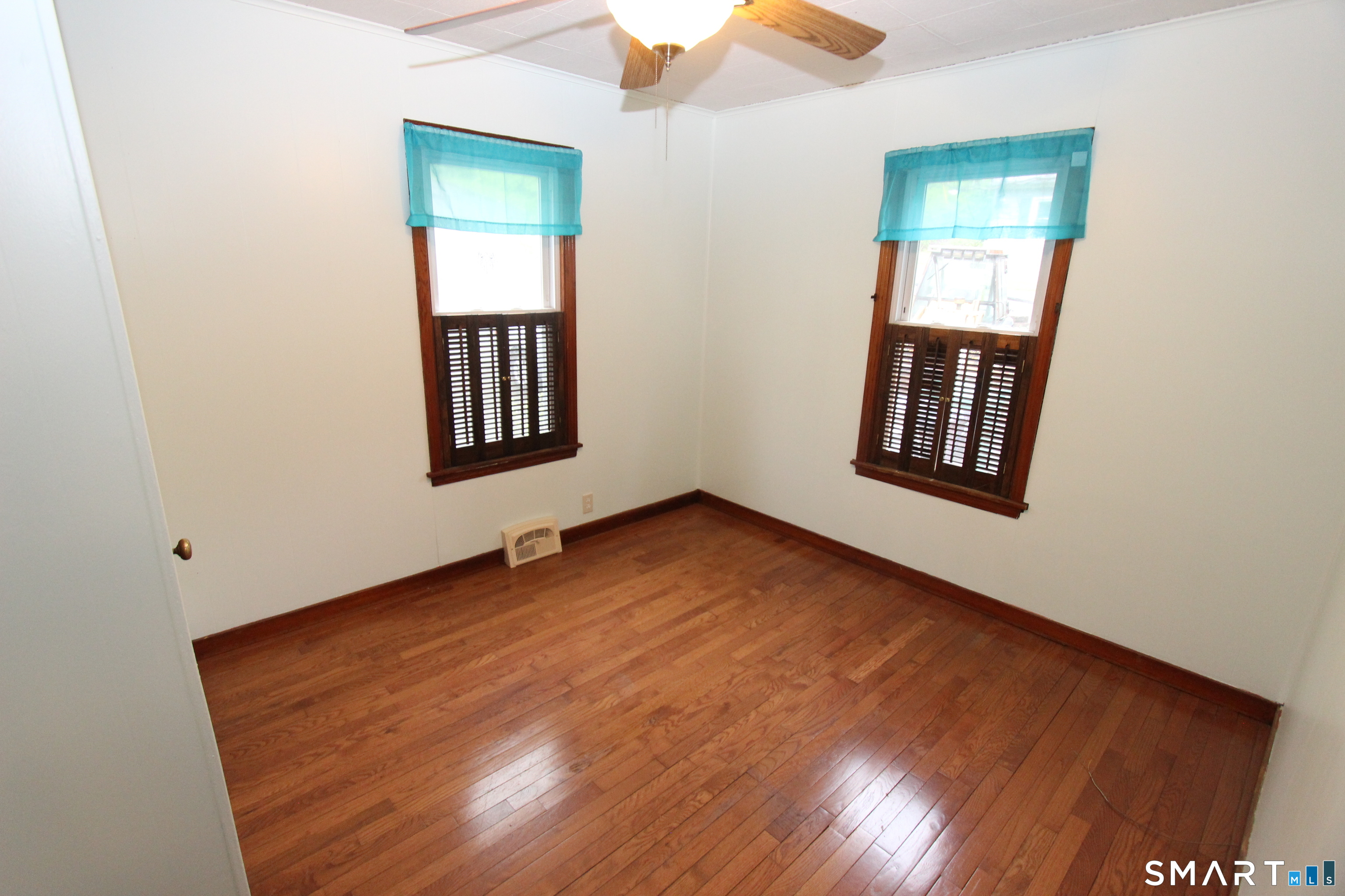 22 Brook Street Seymour, CT 06483 - Photo 9 of 13 an empty room with wooden floor and windows