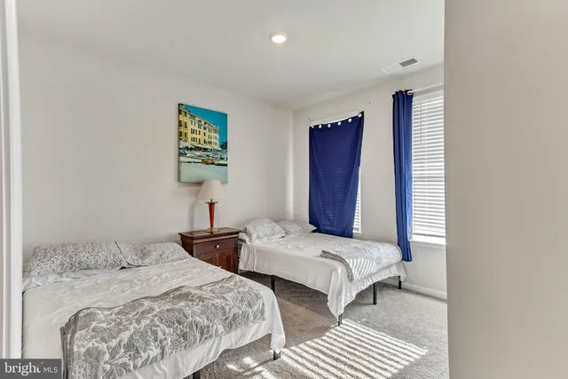 a bedroom with two beds and a window