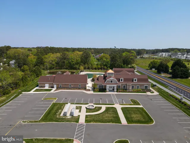 an aerial view of residential houses with outdoor space and parking