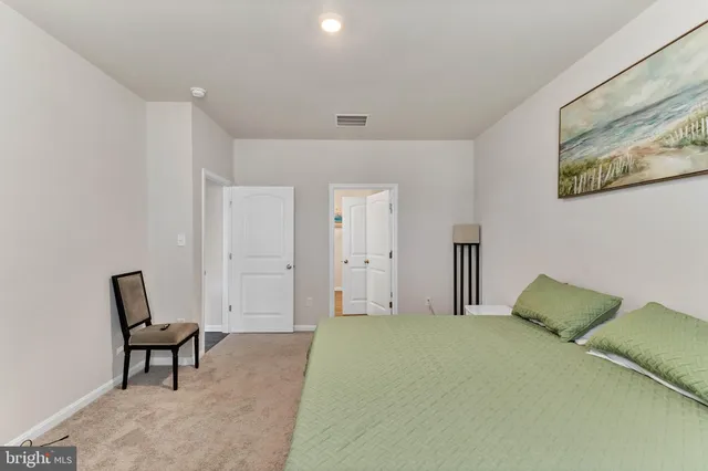 a bedroom with a bed and a chair