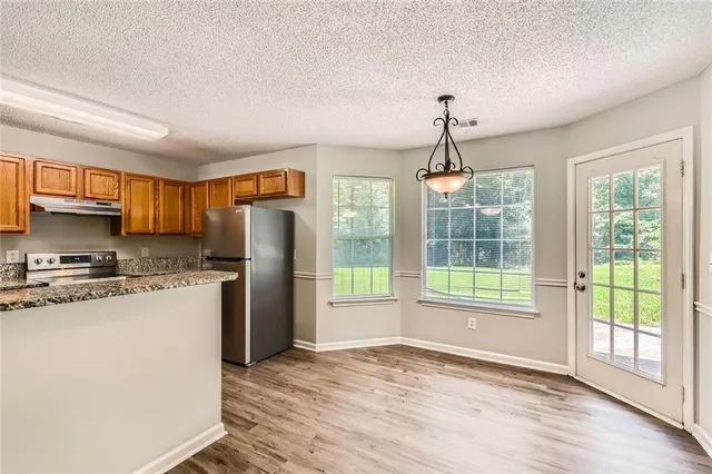 a view of a kitchen with a stove cabinets and a wooden floor