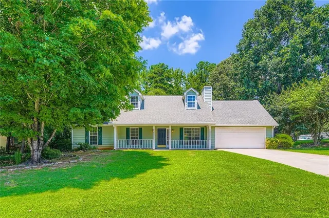 a front view of a house with a garden