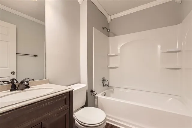 a bathroom with a granite countertop toilet sink and a bathtub