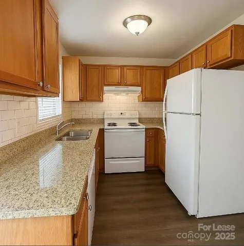 a kitchen with a sink a stove and refrigerator