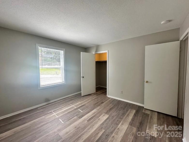 1440 Nottingham Road Kannapolis, NC 28081 - Photo 8 of 13 a view of an empty room with wooden floor and a window
