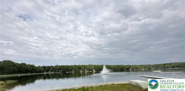 a view of a lake with houses in the back