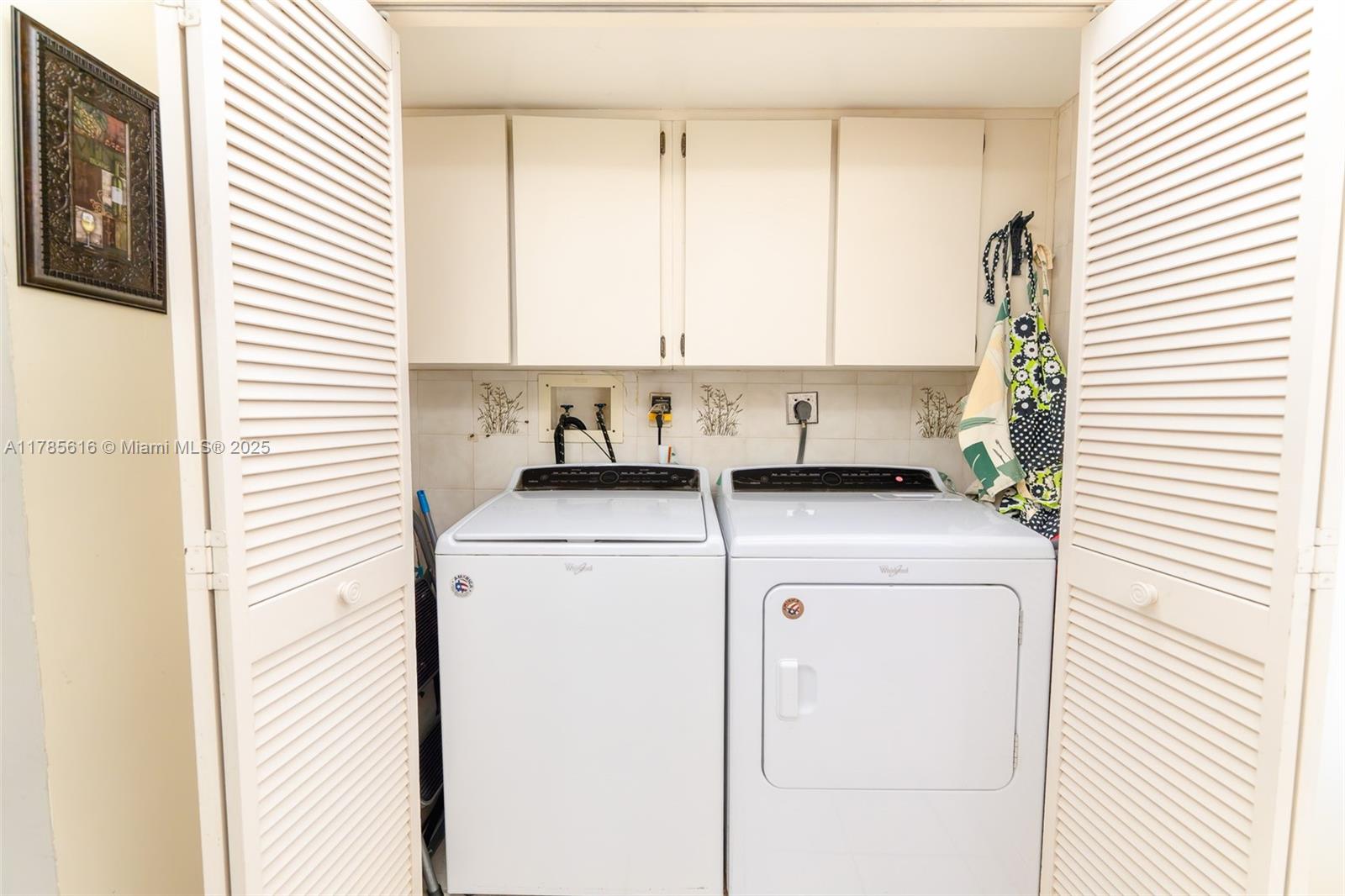 4221 West Palm Aire Drive, Unit 203 Pompano Beach, FL 33069 - Photo 23 of 39 a utility room with dryer and washer