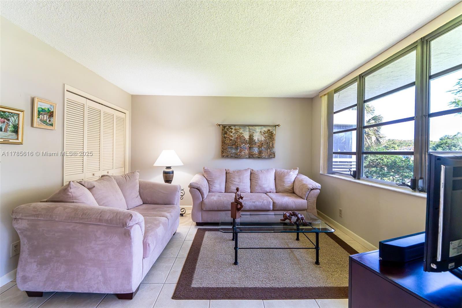 4221 West Palm Aire Drive, Unit 203 Pompano Beach, FL 33069 - Photo 24 of 39 a living room with furniture and a window