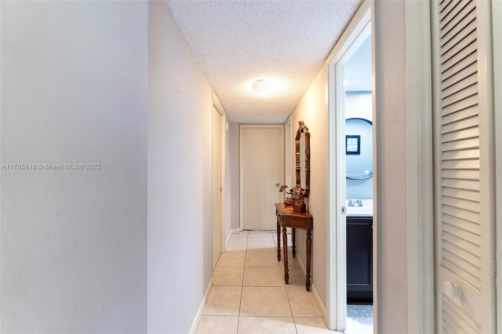 4221 West Palm Aire Drive, Unit 203 Pompano Beach, FL 33069 - Photo 28 of 39 a view of a hallway with a livingroom and a bathroom with sink