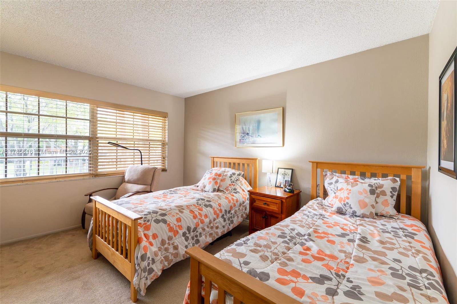 4221 West Palm Aire Drive, Unit 203 Pompano Beach, FL 33069 - Photo 29 of 39 a bedroom with two beds and next to a window