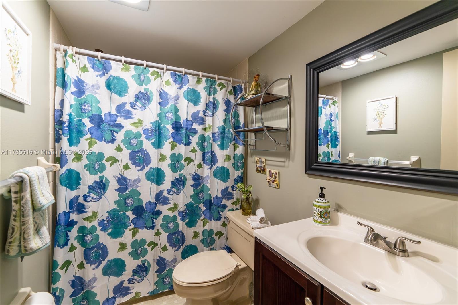 4221 West Palm Aire Drive, Unit 203 Pompano Beach, FL 33069 - Photo 31 of 39 a bathroom with a sink toilet and shower