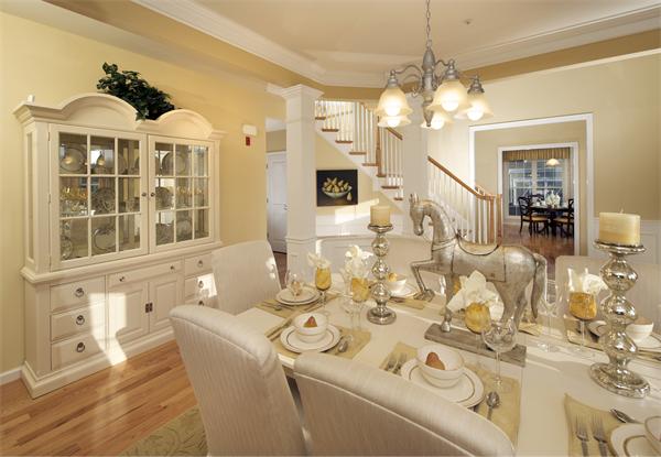 a very nice looking dining room with a large window and chandelier