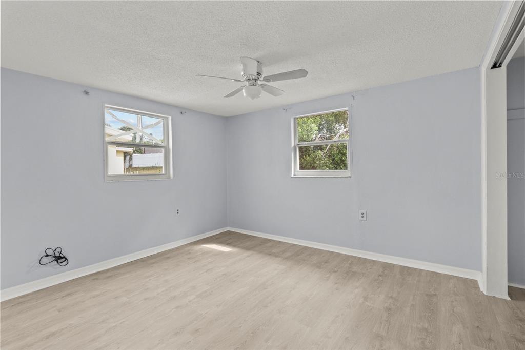 1623 Plum Tree Road Holiday, FL 34690 - Photo 13 of 33 an empty room with windows and fan