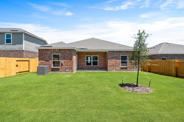 a view of a house with a backyard and a garden