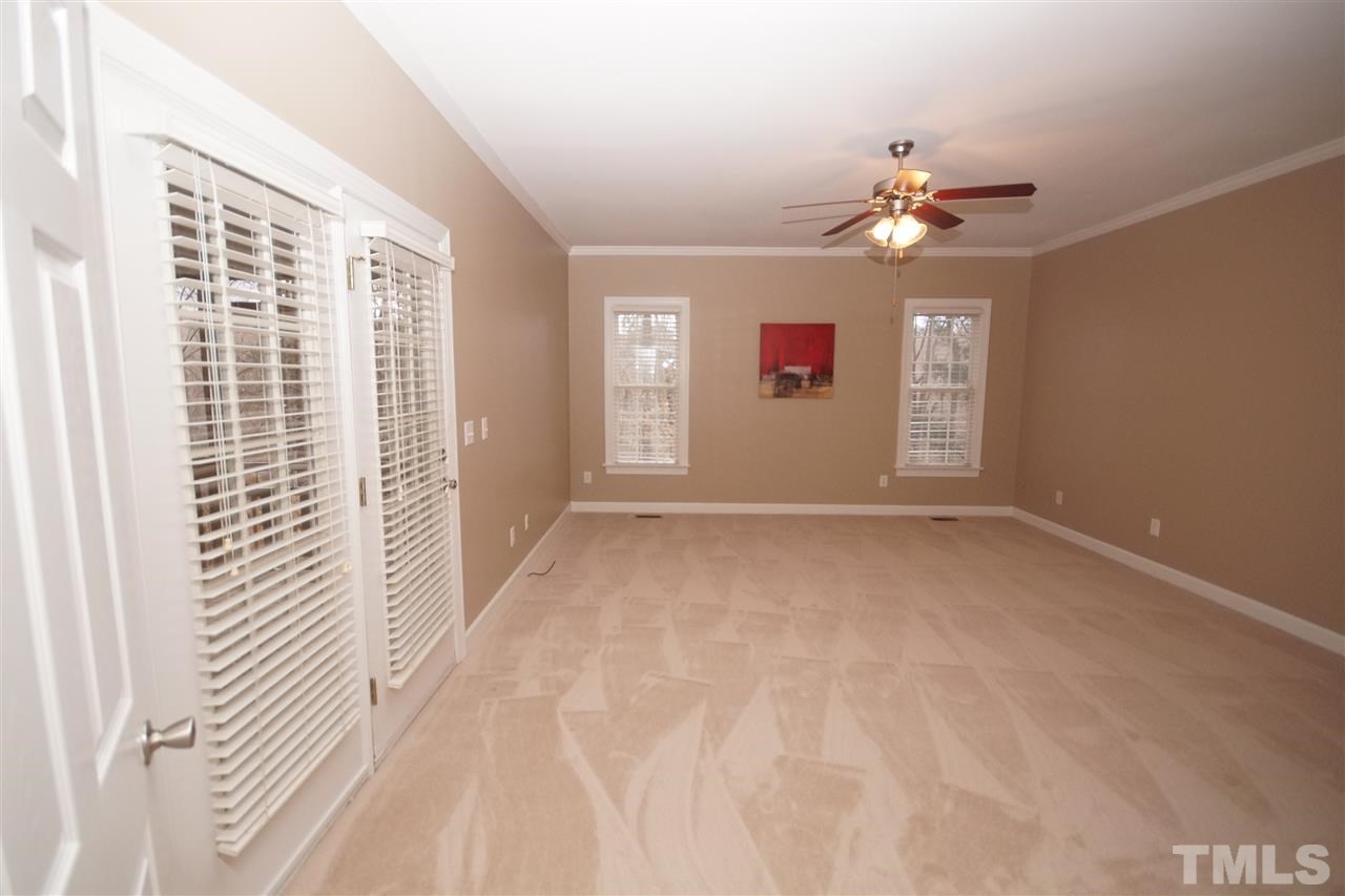 12736 Amoretto Way Raleigh, NC 27613 - Photo 11 of 25 a view of a livingroom with a ceiling fan and window