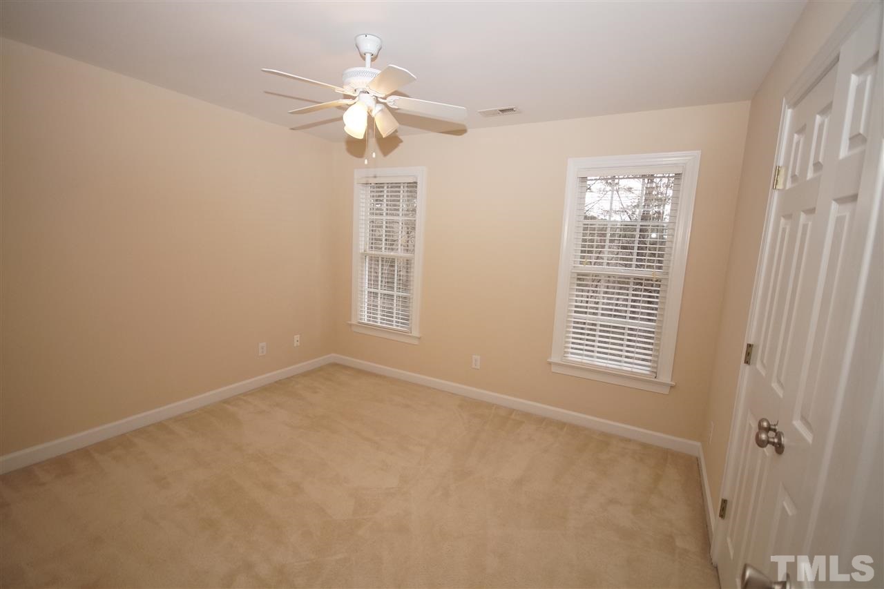 12736 Amoretto Way Raleigh, NC 27613 - Photo 15 of 25 an empty room with windows and fan