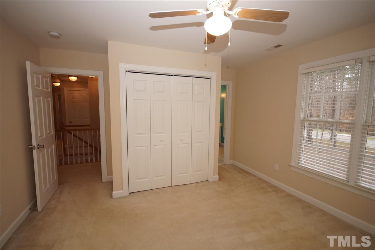 12736 Amoretto Way Raleigh, NC 27613 - Photo 20 of 25 en empty room with windows and fan