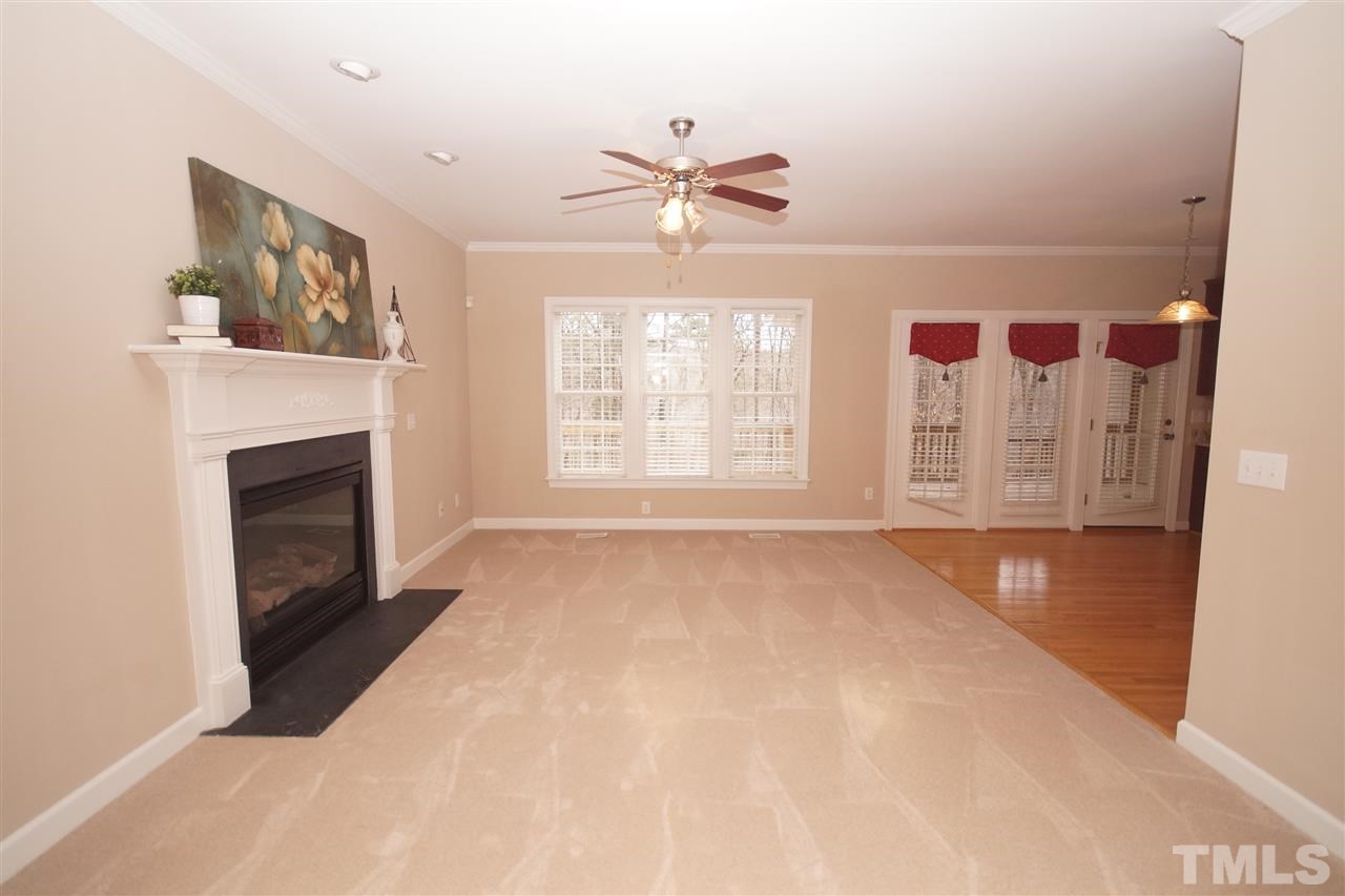 12736 Amoretto Way Raleigh, NC 27613 - Photo 5 of 25 a view of an empty room with a fireplace and a window
