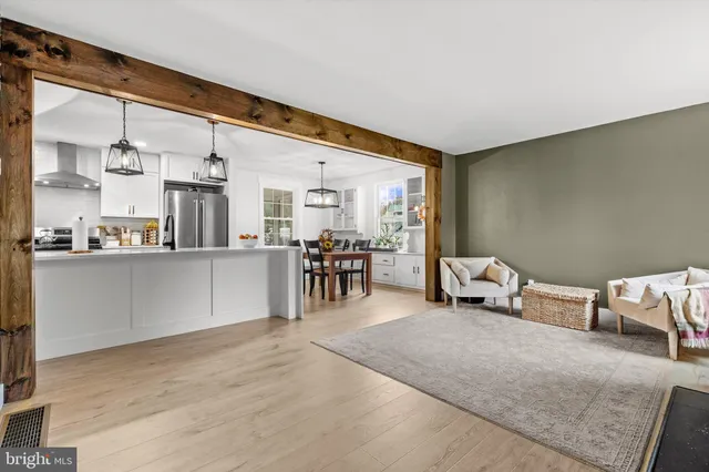 a room with stainless steel appliances furniture and a kitchen view