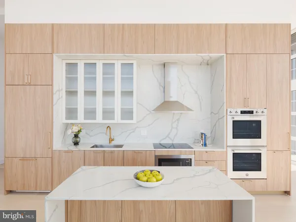 a kitchen with a white cabinets and window