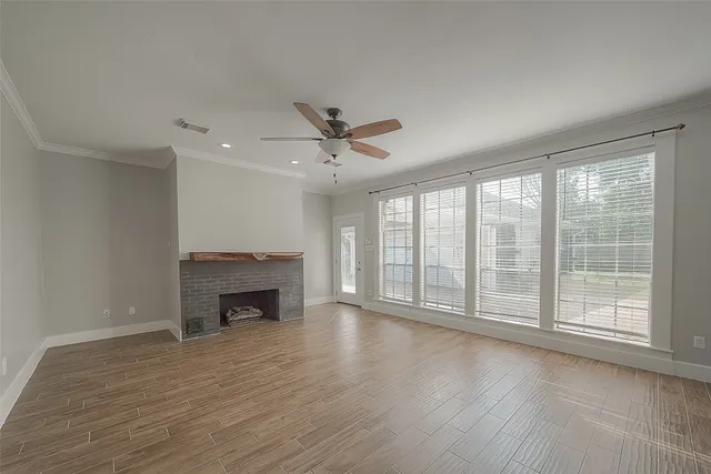 wooden floor fireplace and natural light in room