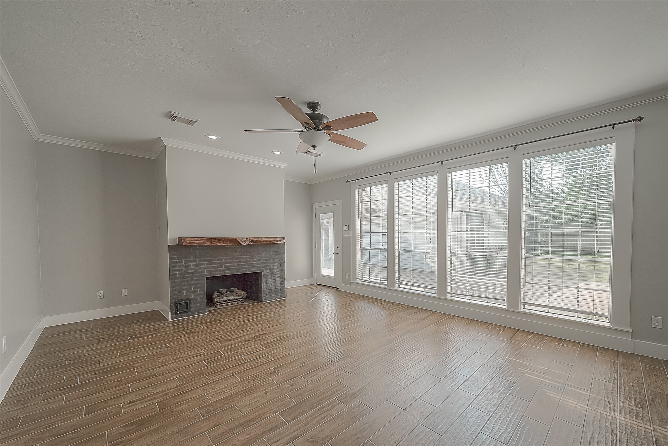 8910 Bonnyview Drive Houston, TX 77095 - Photo 11 of 31 wooden floor fireplace and natural light in room