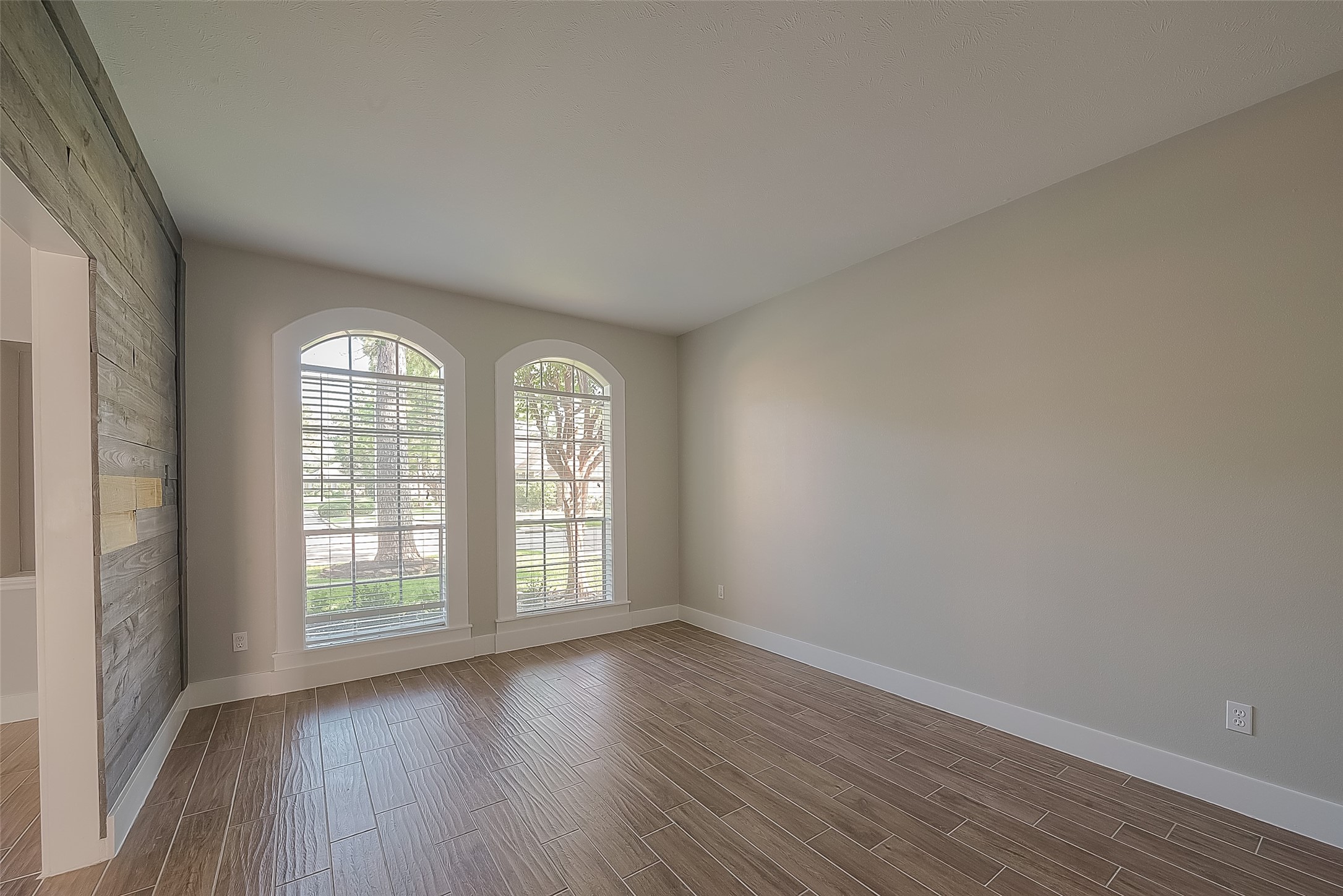 8910 Bonnyview Drive Houston, TX 77095 - Photo 17 of 31 an empty room with wooden floor and windows