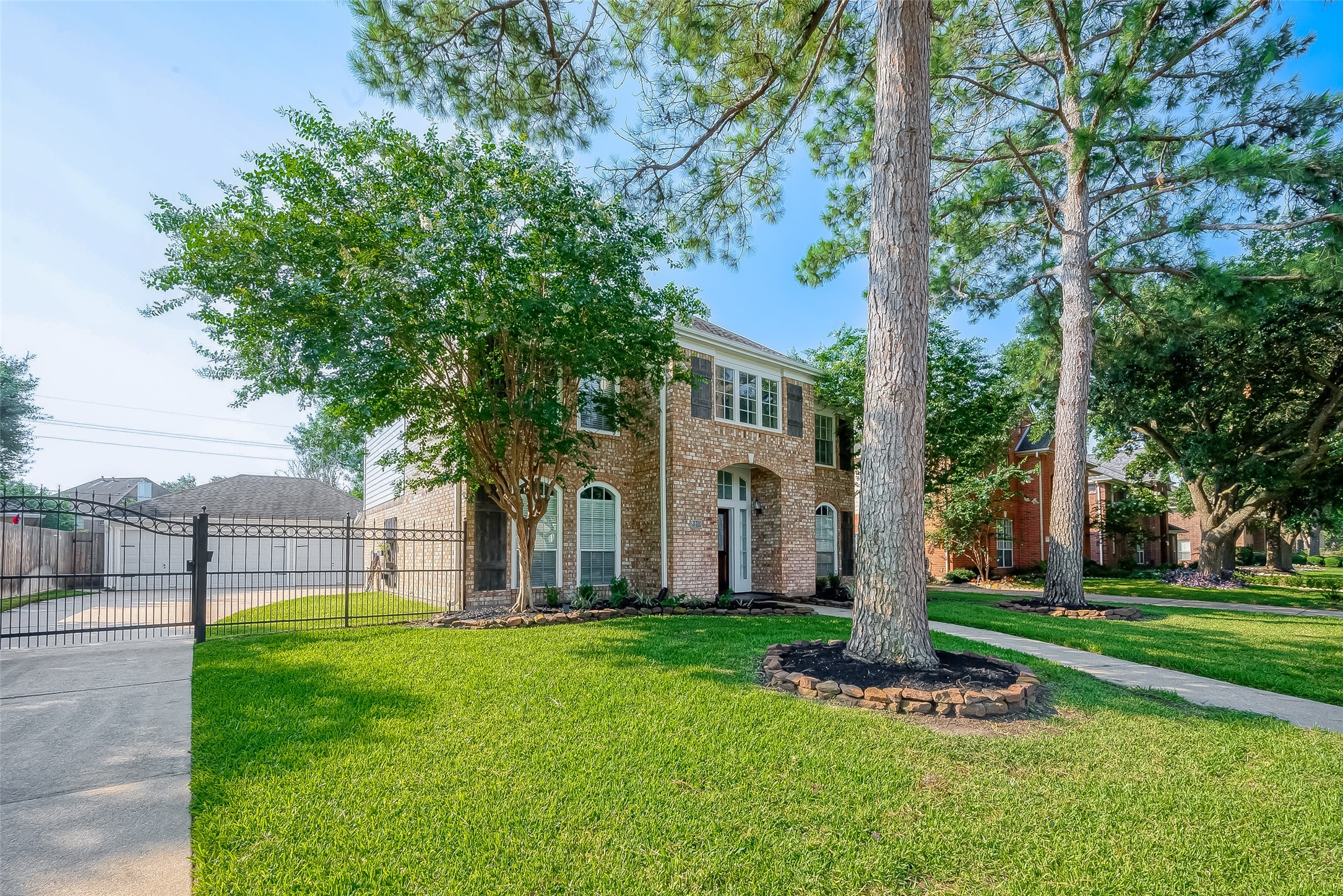 8910 Bonnyview Drive Houston, TX 77095 - Photo 2 of 31 a garden with trees in front of it