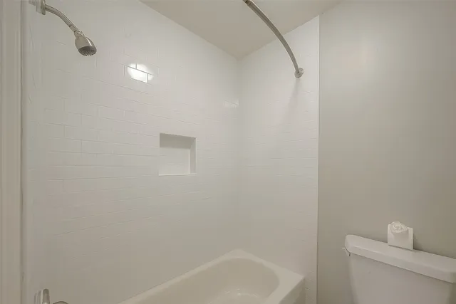 a bathroom with a bathtub and a toilet