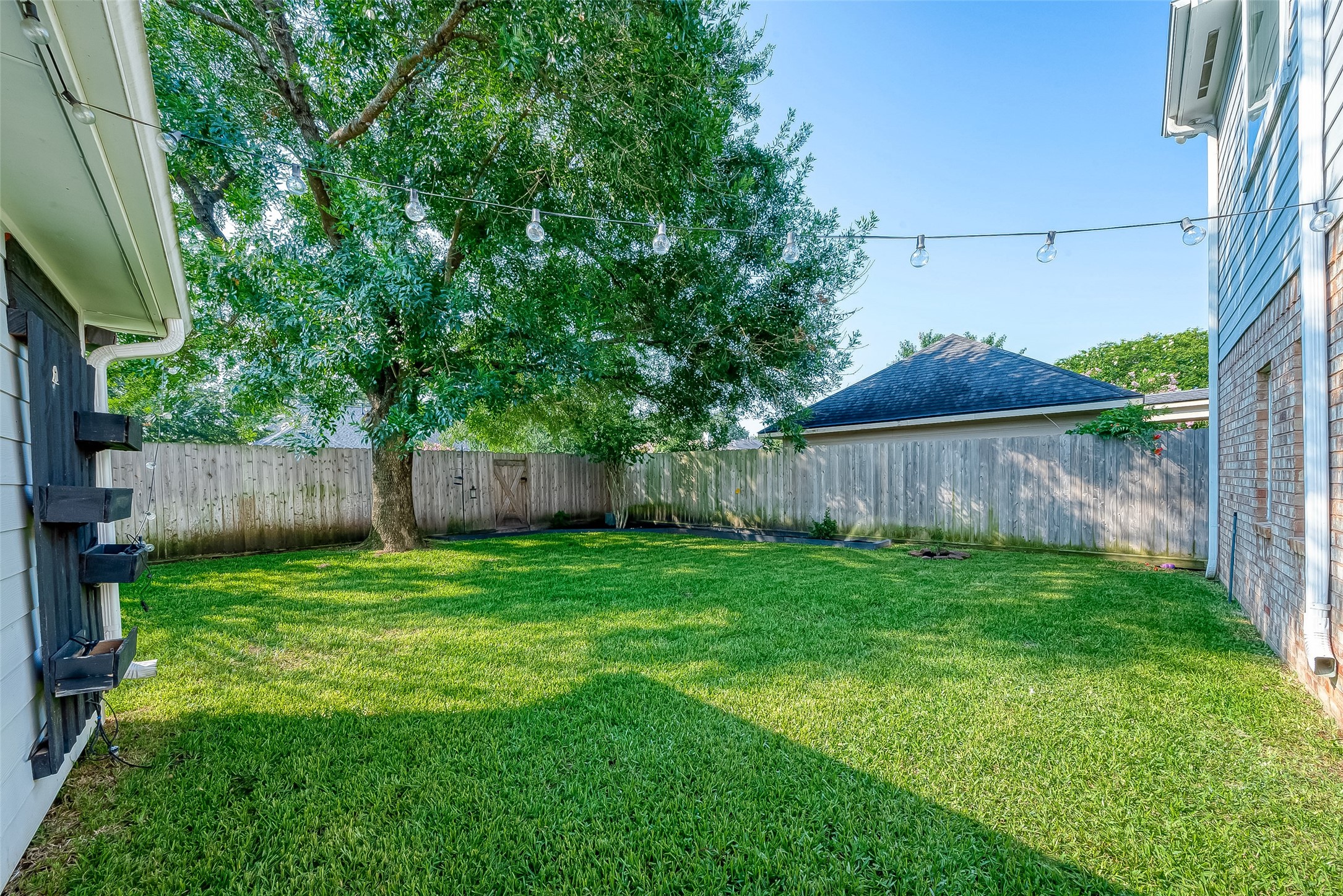 8910 Bonnyview Drive Houston, TX 77095 - Photo 29 of 31 a backyard of a house with lots of plants and wooden fence