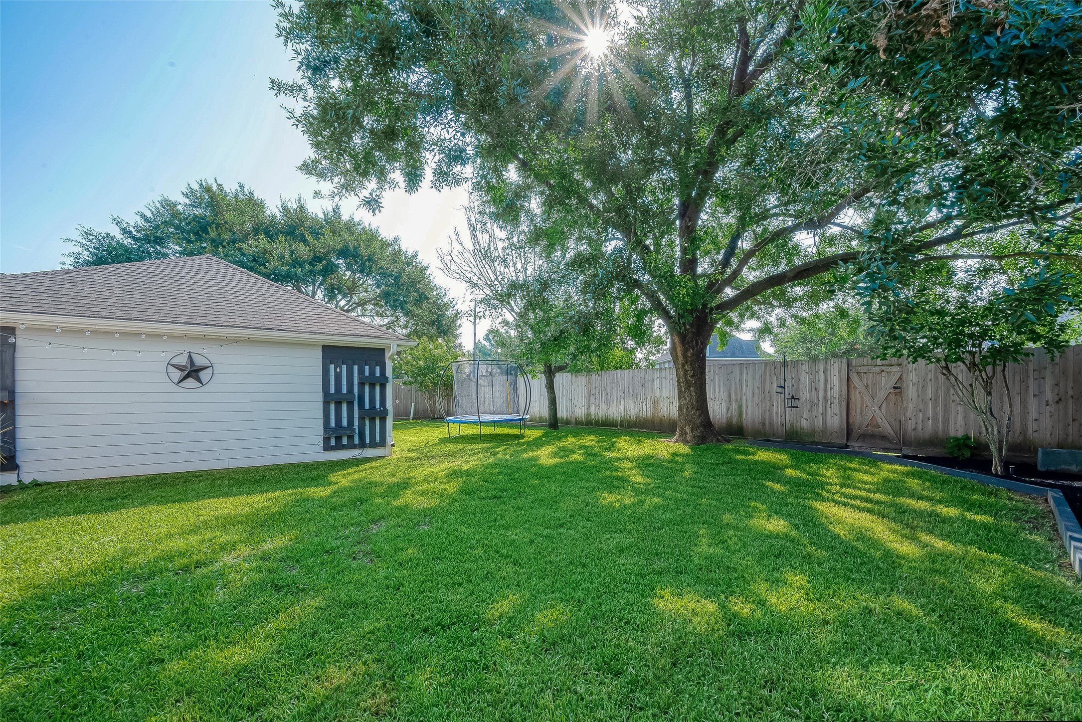 8910 Bonnyview Drive Houston, TX 77095 - Photo 30 of 31 a view of a backyard with large trees and wooden fence