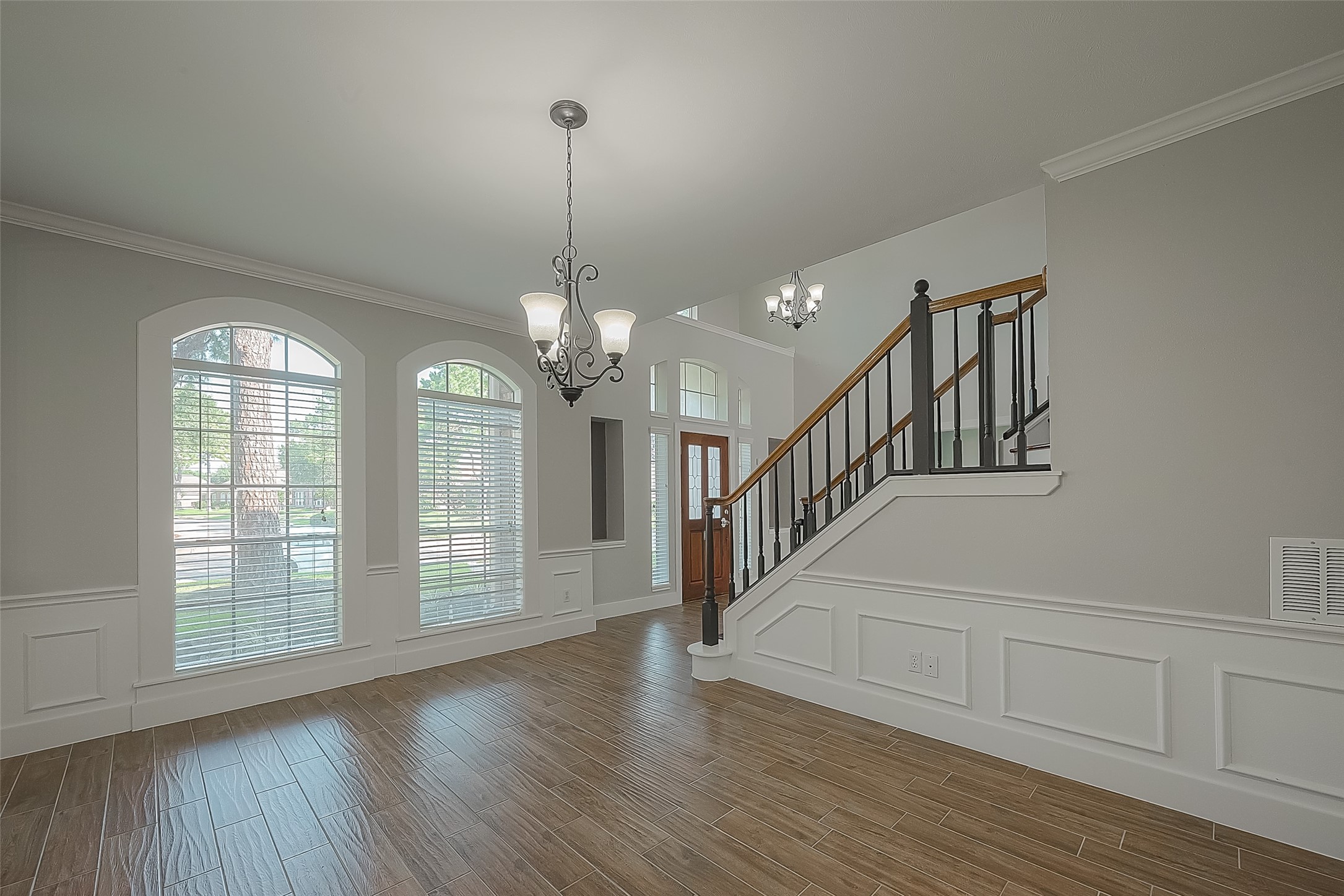 8910 Bonnyview Drive Houston, TX 77095 - Photo 5 of 31 a view of an empty room with wooden floor floors and a chandelier