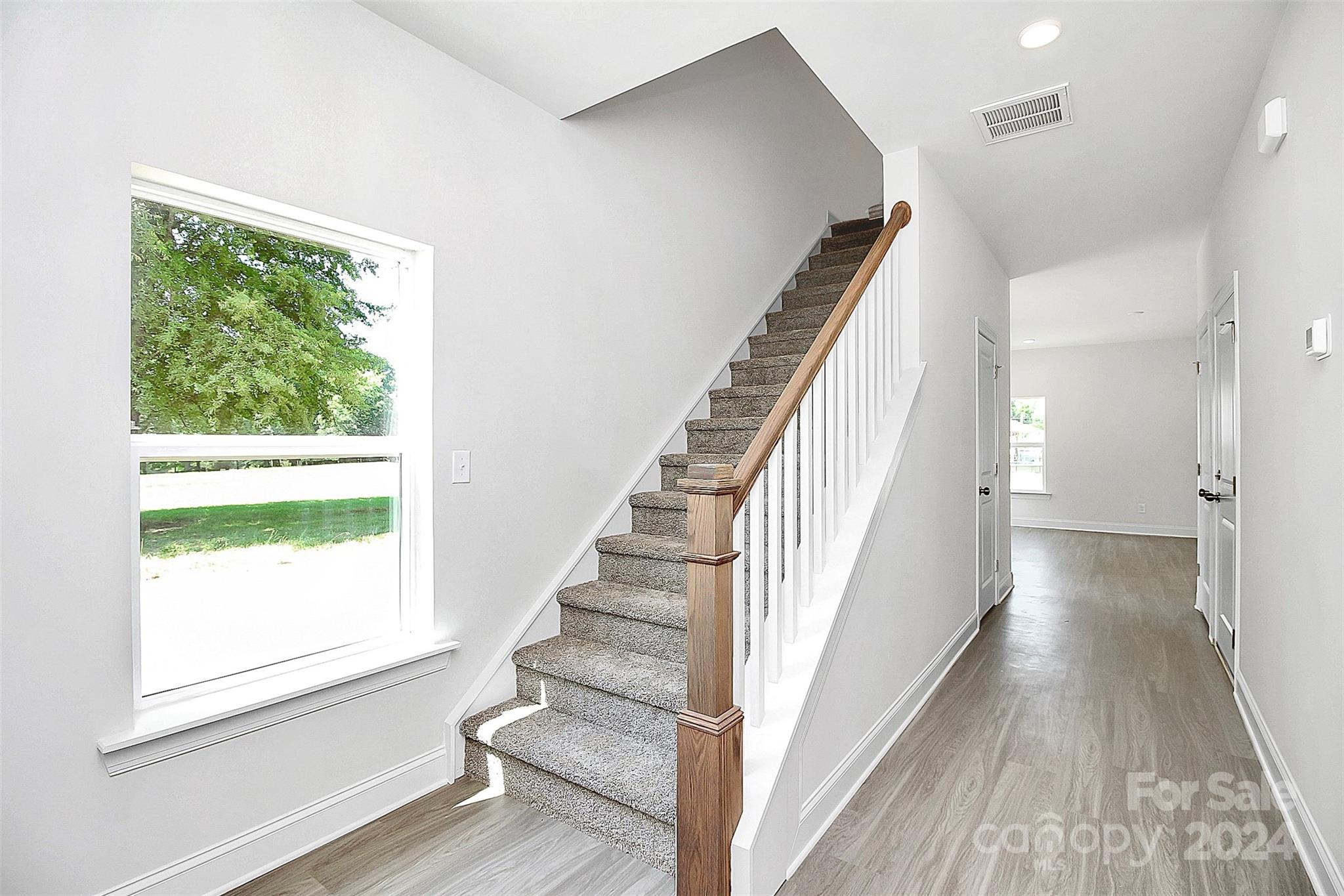 1418 Azalea Avenue Kannapolis, NC 28081 - Photo 14 of 39 a view of a hallway with wooden floor and staircase