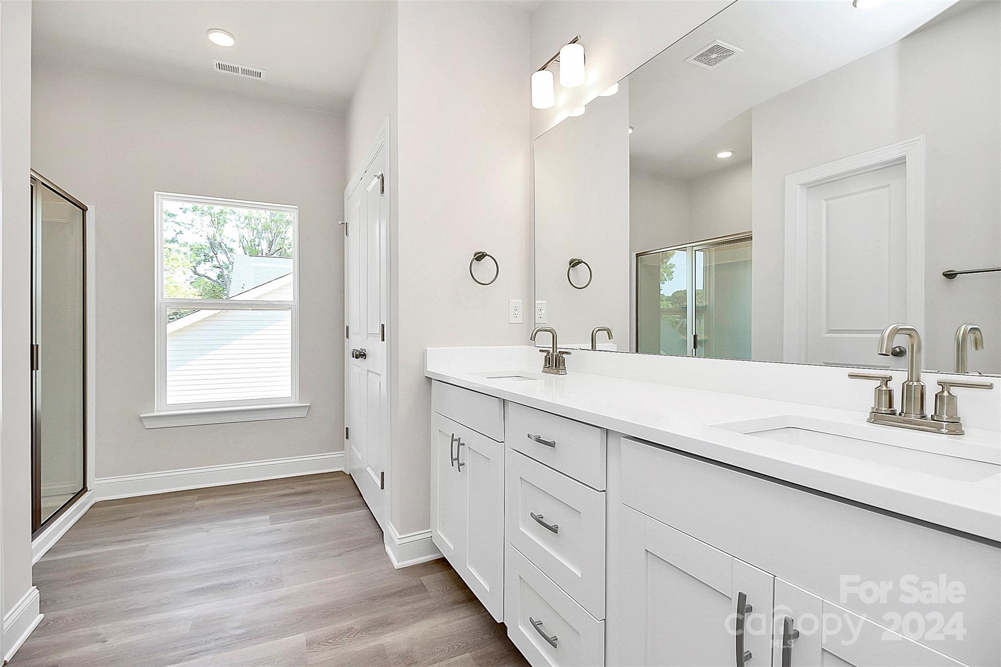 1418 Azalea Avenue Kannapolis, NC 28081 - Photo 17 of 39 a bathroom with double vanity sink a mirror a window and vanity