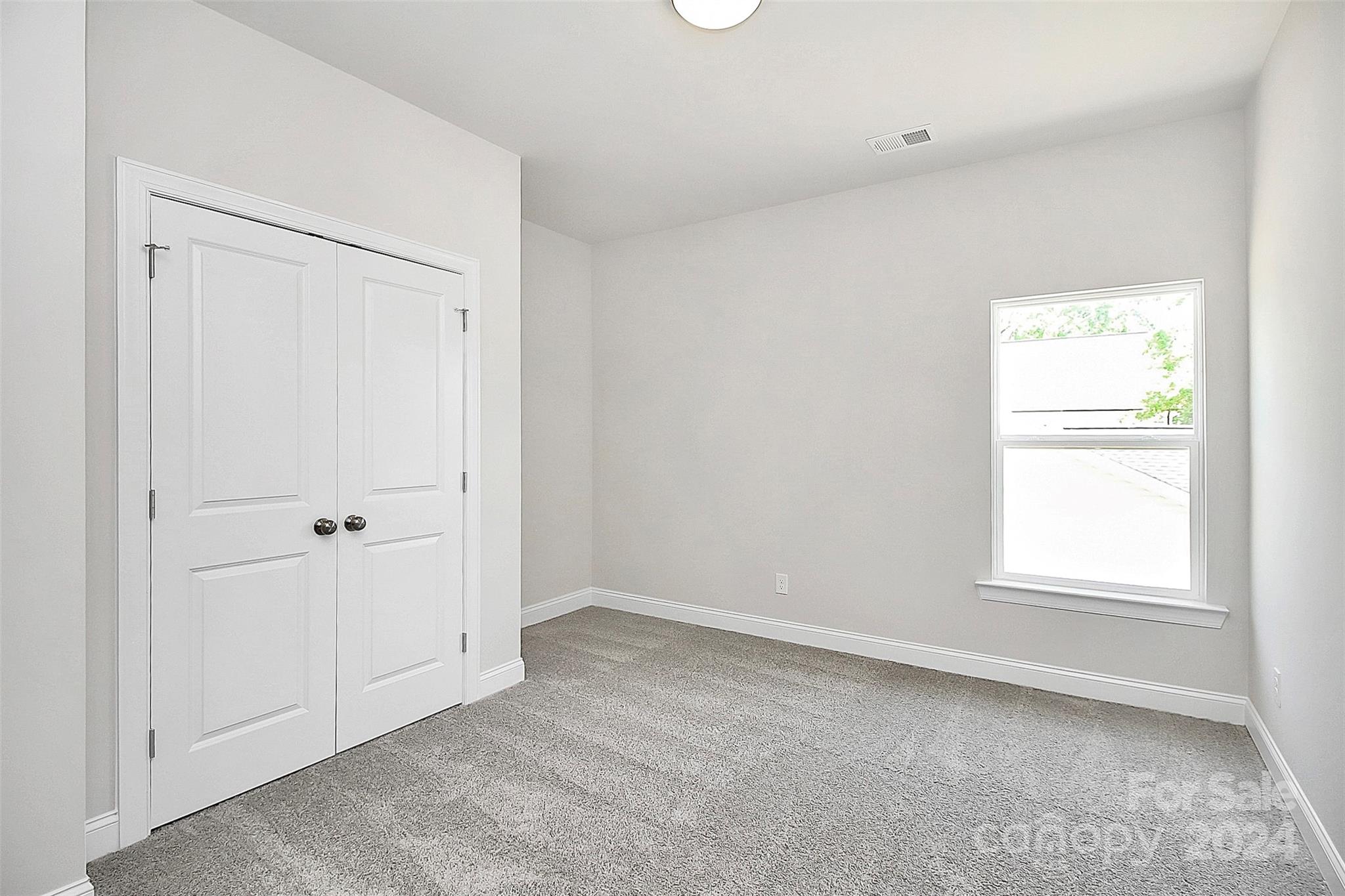 1418 Azalea Avenue Kannapolis, NC 28081 - Photo 23 of 39 an empty room with windows and closet