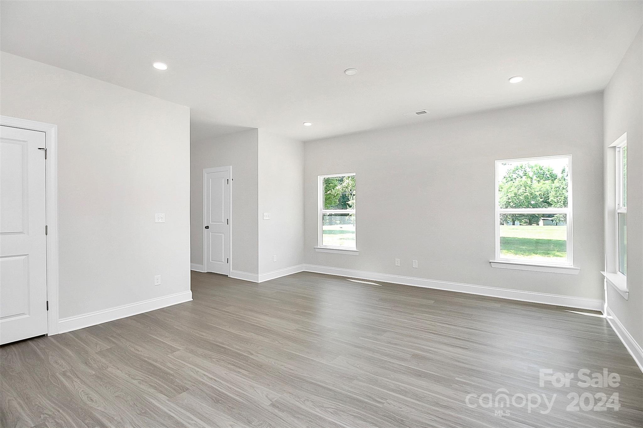 1418 Azalea Avenue Kannapolis, NC 28081 - Photo 7 of 39 an empty room with wooden floor and windows