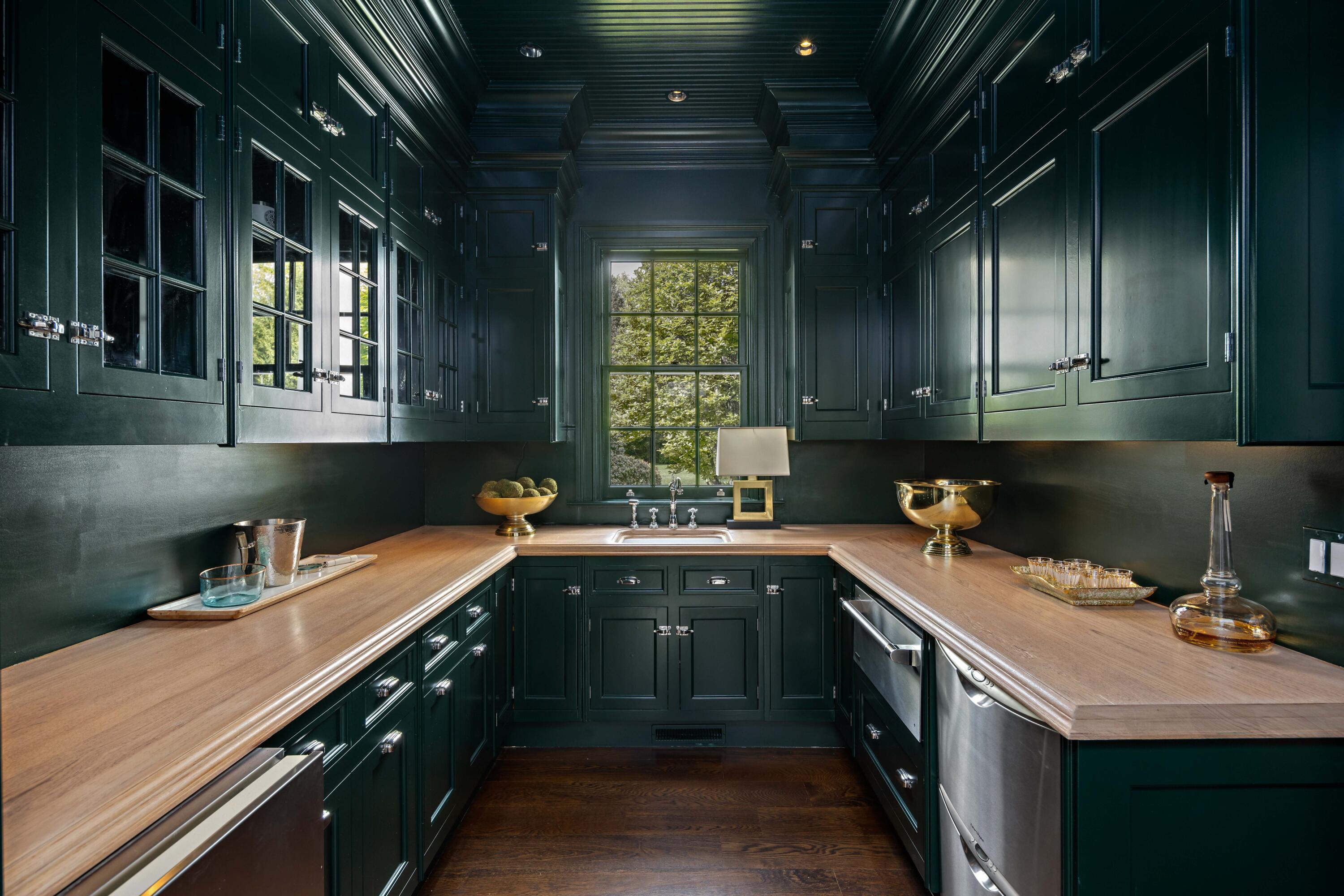 625 Oenoke Ridge New Canaan, CT 06840 - Photo 16 of 40 a kitchen with a sink stove and cabinets