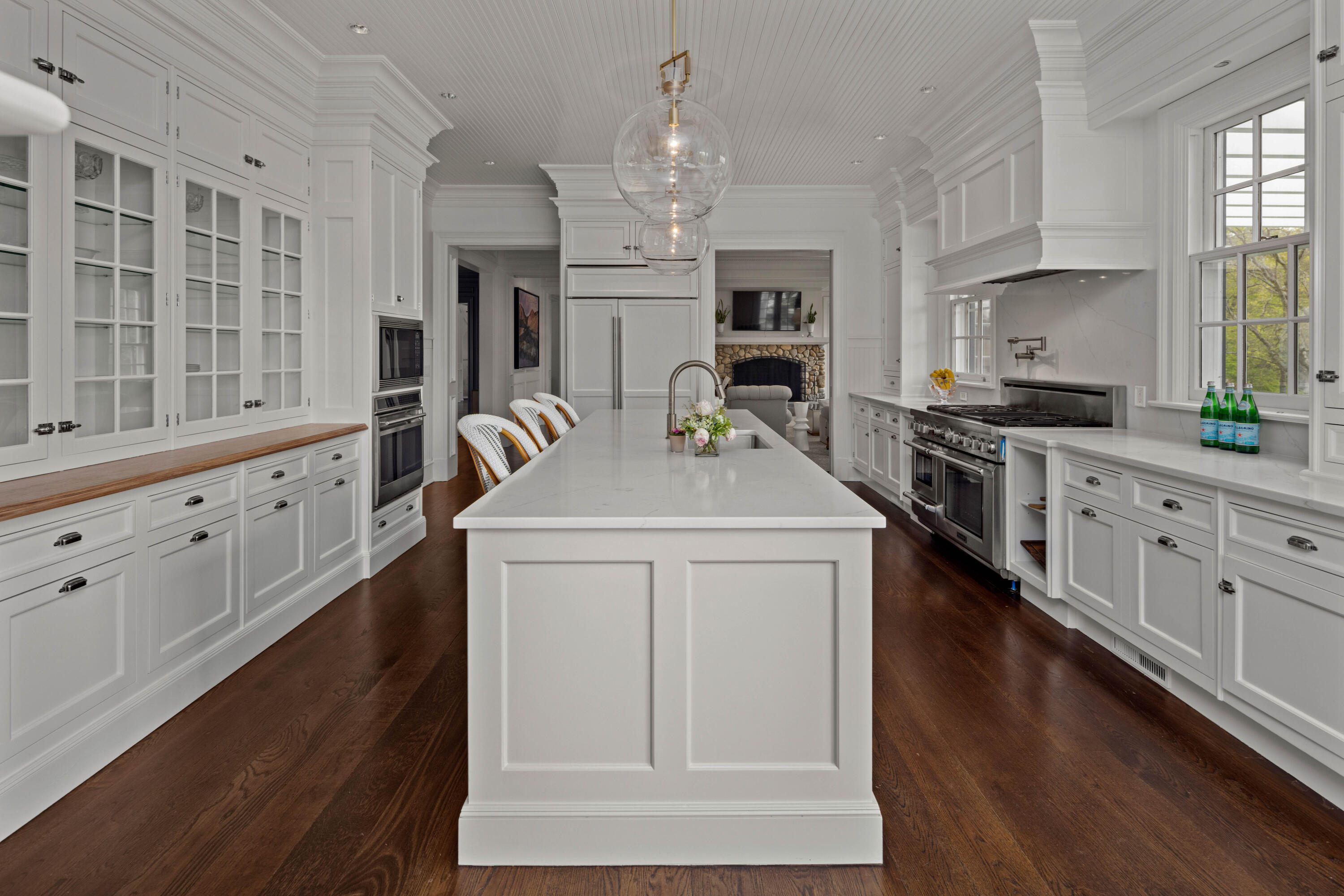 625 Oenoke Ridge New Canaan, CT 06840 - Photo 21 of 40 a kitchen with stainless steel appliances granite countertop a stove a sink dishwasher and white cabinets with wooden floor