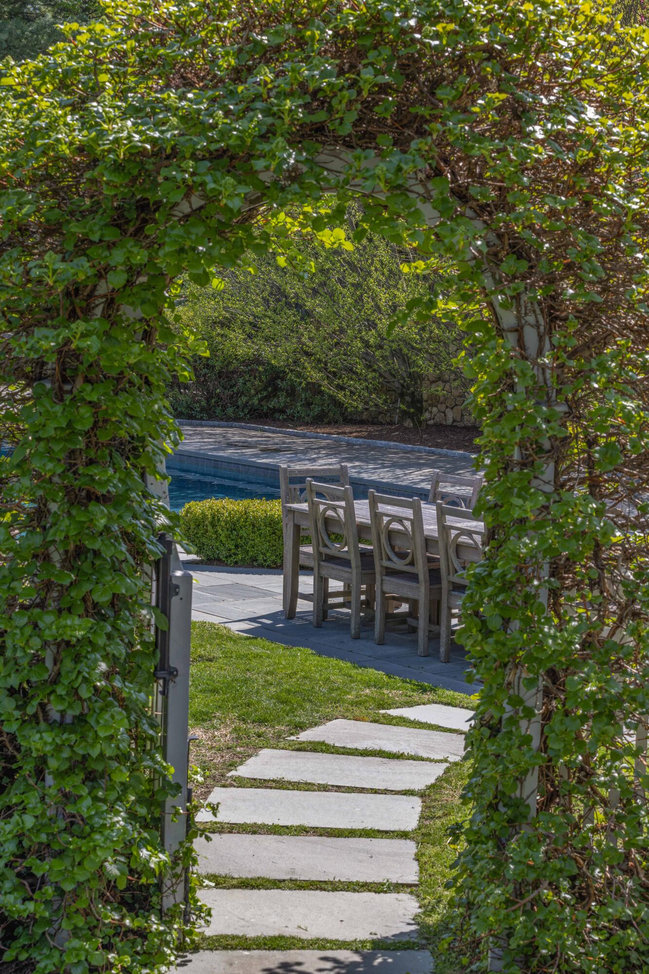 625 Oenoke Ridge New Canaan, CT 06840 - Photo 32 of 40 a view of a house with a small yard plants and large tree