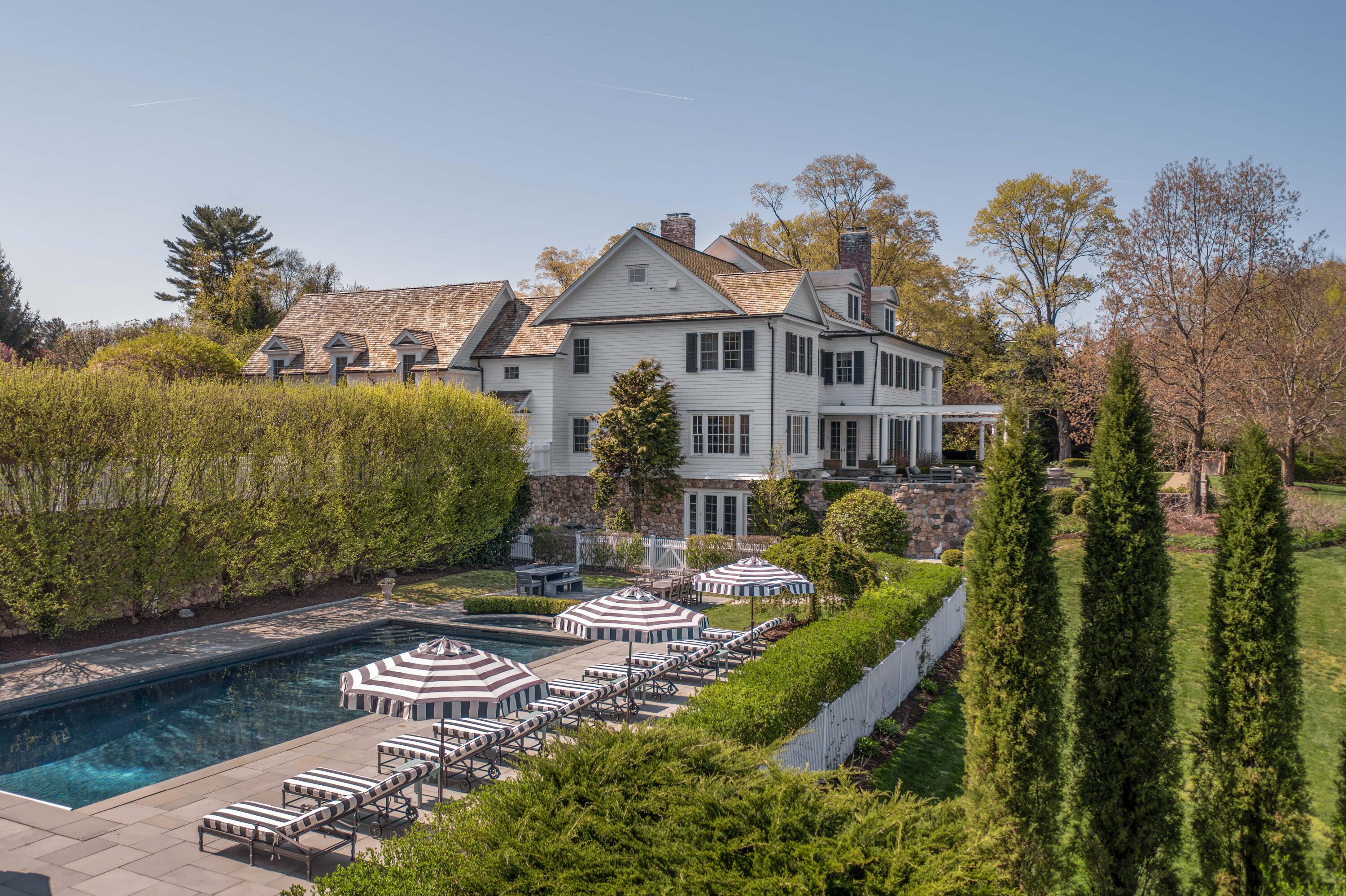 625 Oenoke Ridge New Canaan, CT 06840 - Photo 33 of 40 a view of a house with backyard water fountain and sitting area