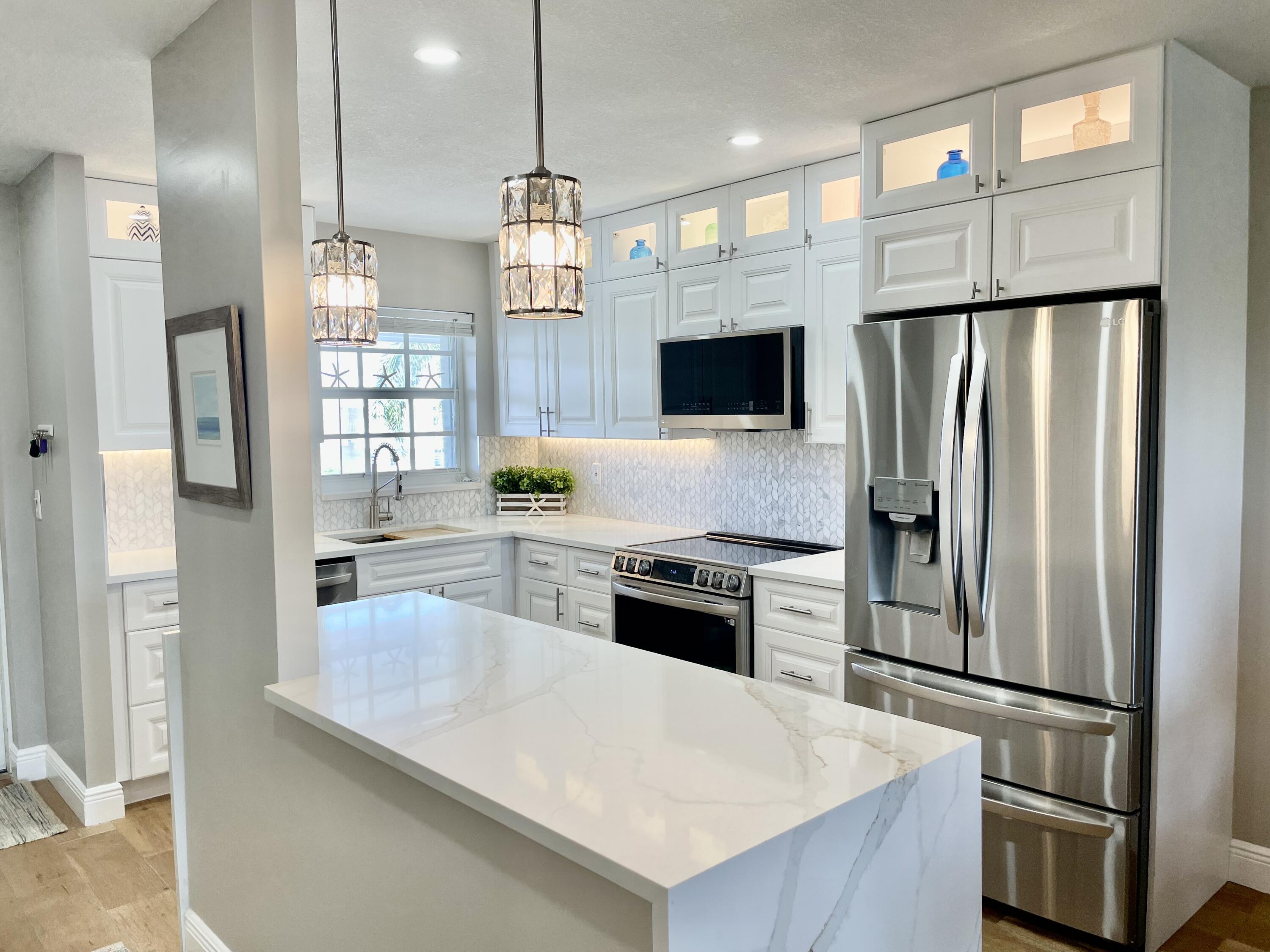 1030 Sugar Sands Boulevard, Unit 372 Riviera Beach, FL 33404 - Photo 5 of 45 New Quartz and marble kitchen