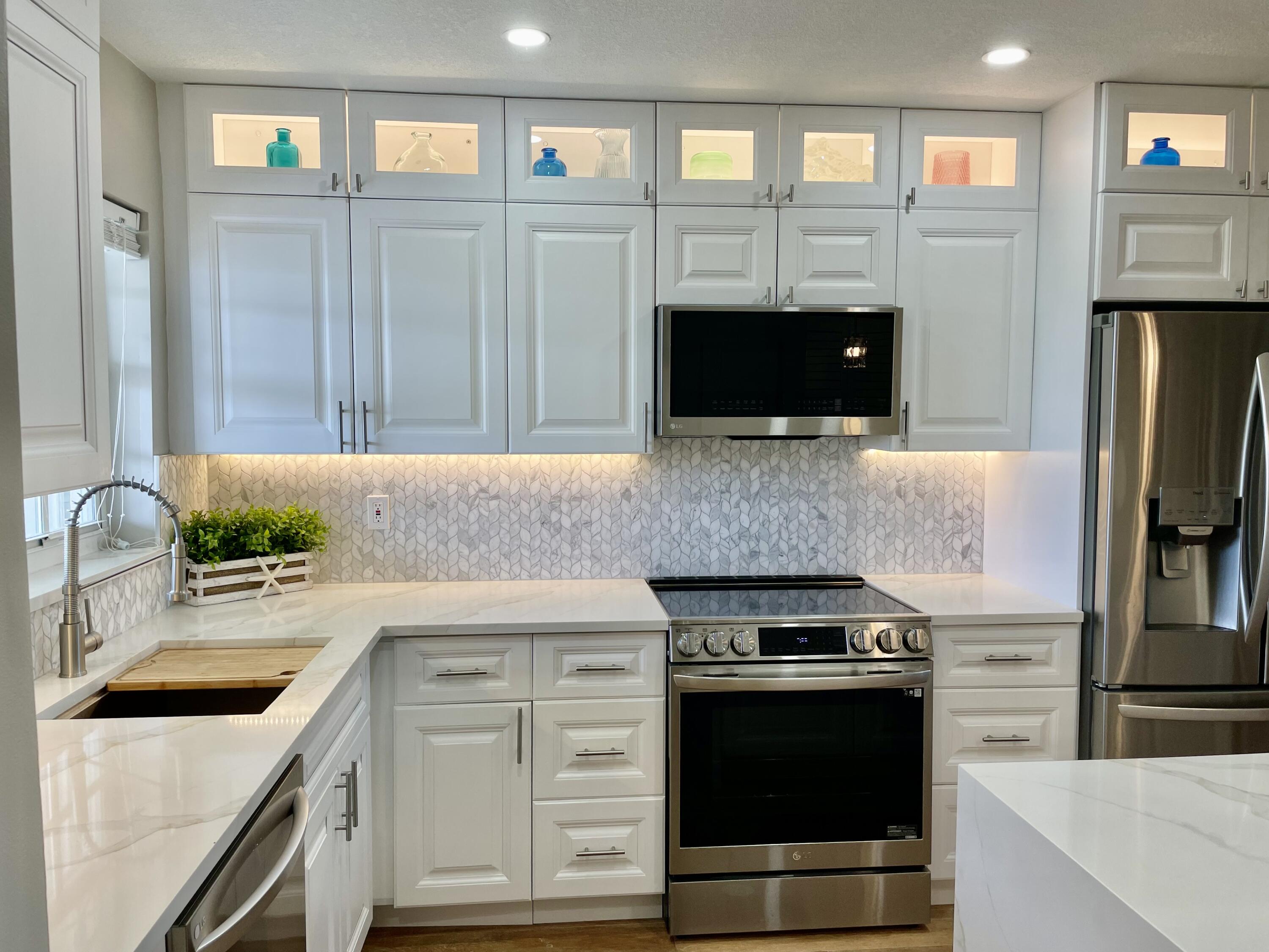 1030 Sugar Sands Boulevard, Unit 372 Riviera Beach, FL 33404 - Photo 6 of 45 Extended height backlit cabinets