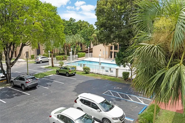 a view of a backyard with plants and trees