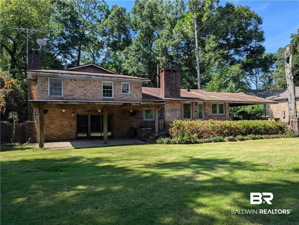 3608 Linden Lane Mobile, AL 36608 - Photo 2 of 20 Rear view of house featuring a patio and a lawn