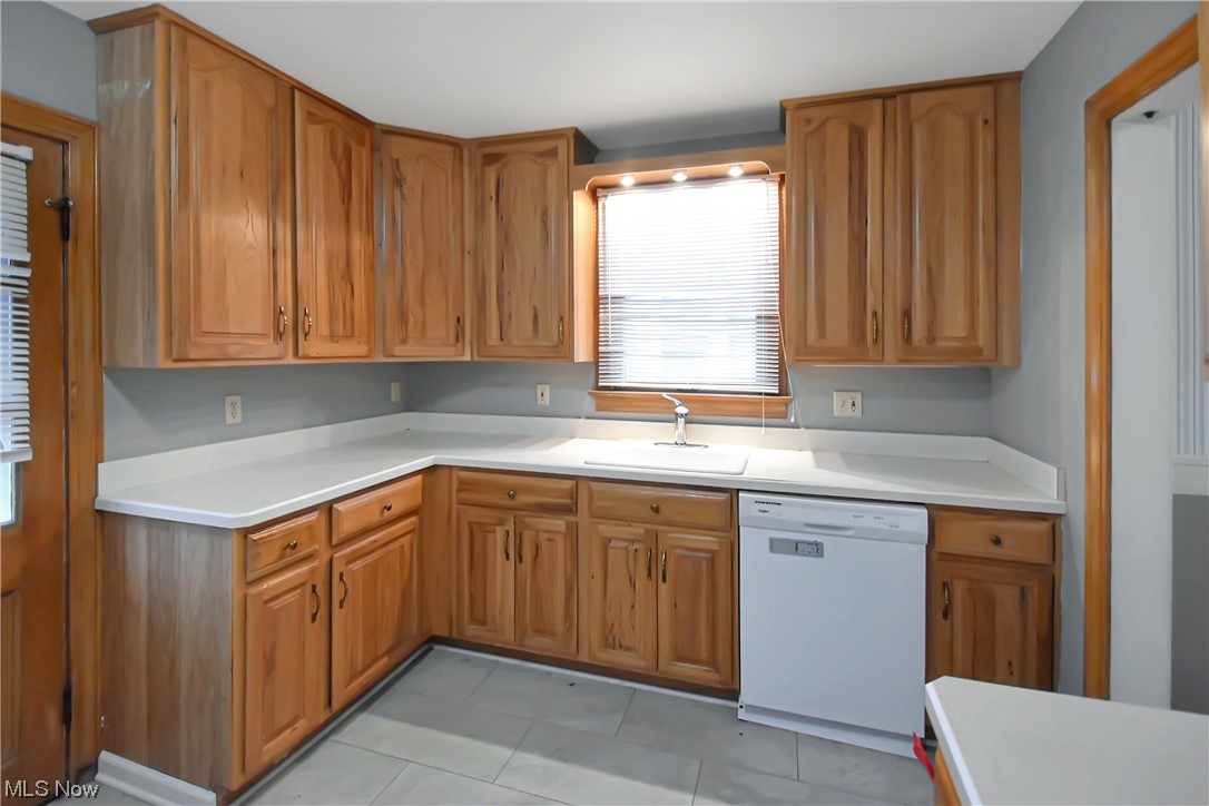 1068 Rushleigh Road Cleveland Heights, OH 44121 - Photo 7 of 22 Kitchen featuring sink, dishwasher, and light tile floors