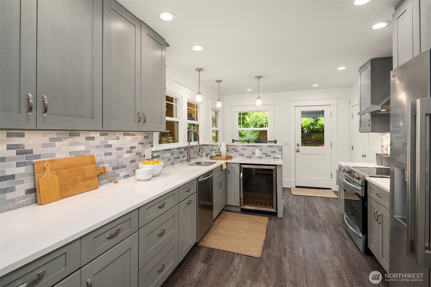 519 27th Avenue Seattle, WA 98122 - Photo 8 of 38 a kitchen with stainless steel appliances granite countertop a sink stove and refrigerator